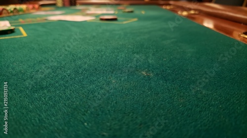 Poker table surface features a green felt texture with blurred cards and chips in the background.