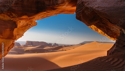 Desert Dunes Framed By Abstract Sandstone Formation