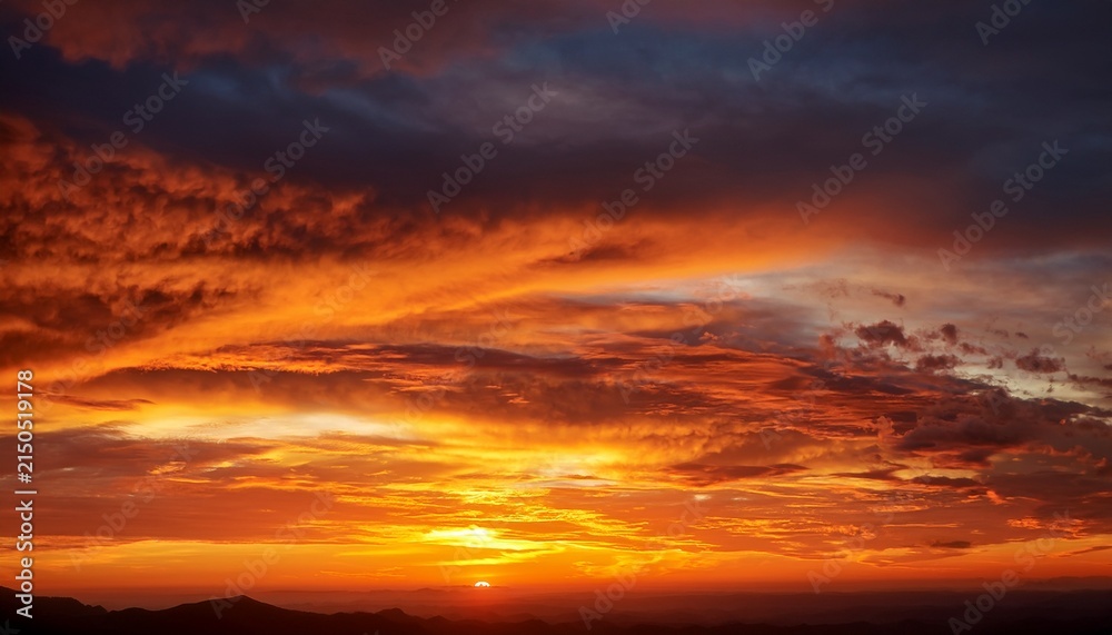 Fototapeta premium Vivid Atmospheric Golden And Orange Colors Fill The Sky During Dawn Perfect Natural Background Image Displaying Morning Light Illuminated Dramatic Wallpaper