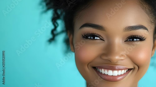 Woman's radiant smile is the focal point of this . Her skin is glowing and her eyes have a mesmerizing depth. This portrait would be perfect for beauty campaigns or lifestyle .