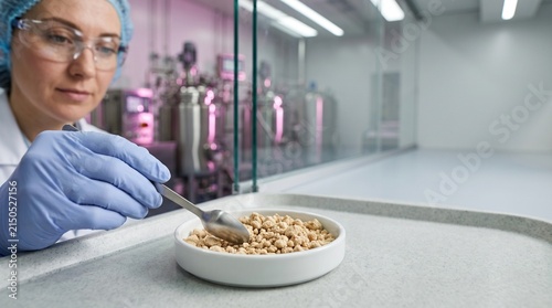 Food scientist assesses cultured protein powder at a lab bench
