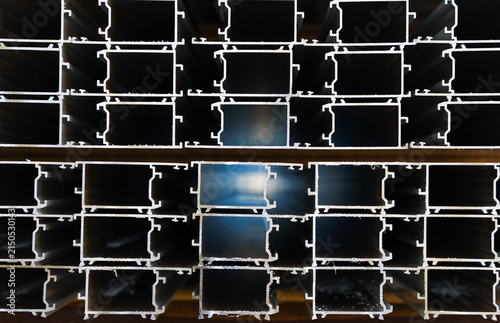 Stacked thermal break aluminum alloy window profiles stored in factory workshop