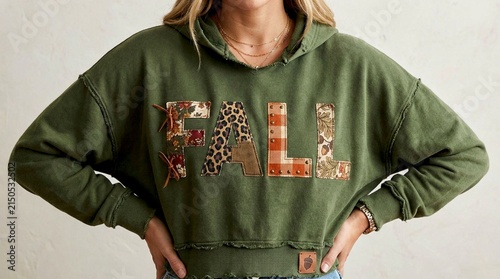A young woman wearing a casual green hoodie with the word 