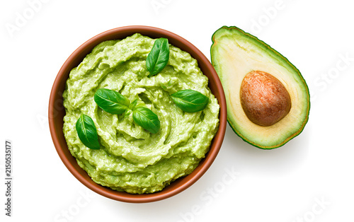 Bowl with guacamole and ripe avocado on white background, top view