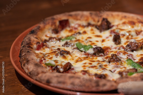 Obraz na plátně Delicious cheesy meat bell pepper Italian pizza on baking tray