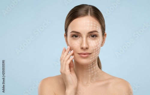 Young woman touching face with mesh facial grid overlay for cosmetic treatment cosmetic skincare treatment wellness