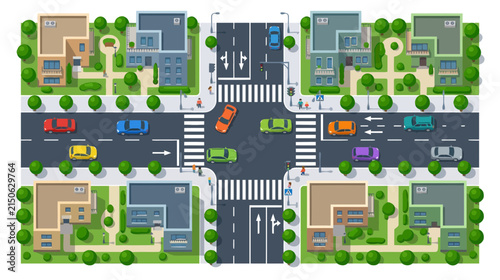 Aerial view of a busy suburban intersection with cars, houses, and traffic lights.