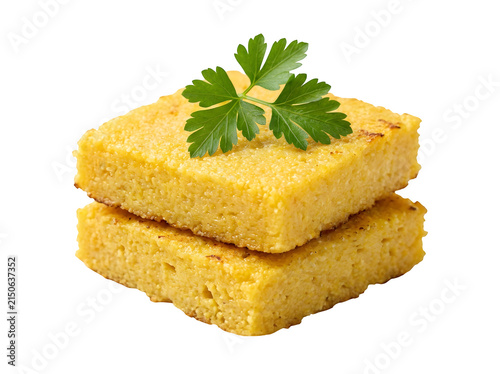 Two square slices of golden yellow cornmeal polenta topped with fresh parsley isolated on transparent background