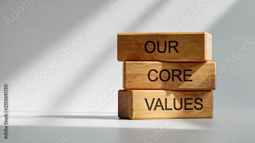 Core values concept with stacked wooden blocks arranged on a minimalist background