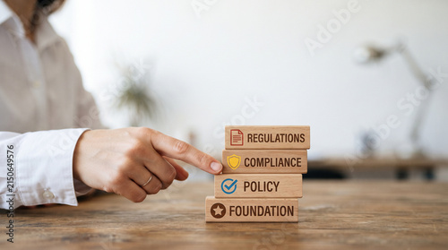 Ai agent permission management policy compliance regulation foundation hand pointer office desk wooden block stack