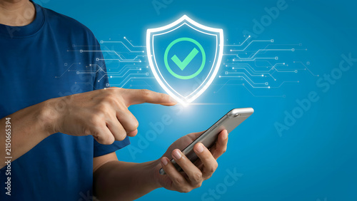 Person Using Smartphone with Digital Shield Icon for Mobile Cybersecurity and Data Protection
