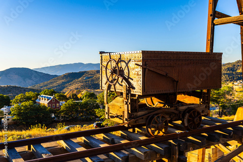 фотографія Iconic rusty minecart with Virginia City cityscape
