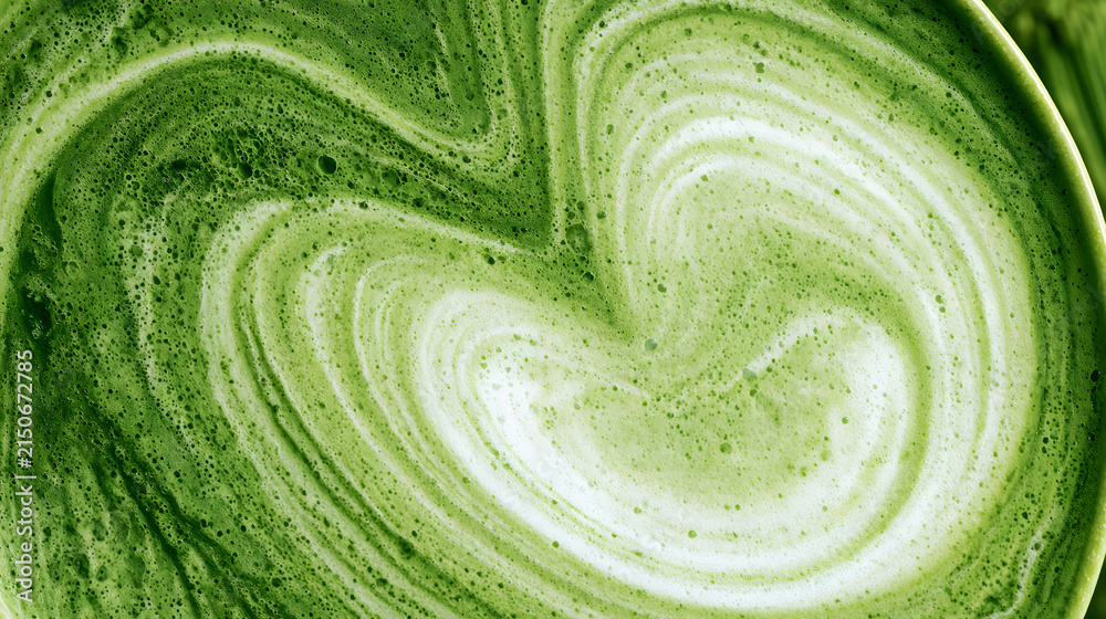 Fototapeta premium a frothy matcha latte, known for its distinctive emerald hue and subtle swirls of creamy foam, captured in both macro and wide-angle shots, featuring a detailed texture close-up and viewed from the to