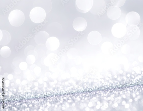 Abstract background of shimmering silver glitter and bokeh lights