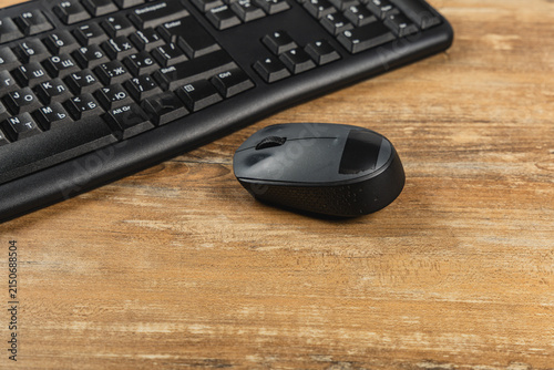 Office workspace with computer keyboard and mouse on wooden desk