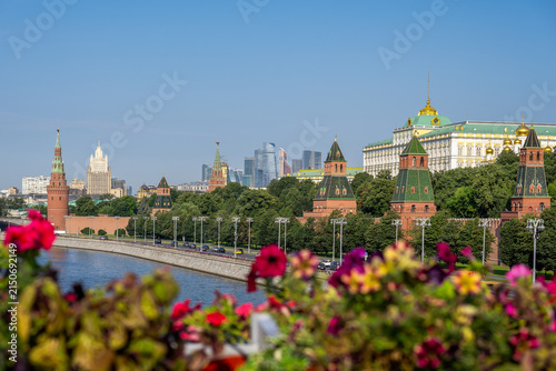 Summer morning on the Kremlin Embankment of the Moscow River with bright flowers, Moscow city in Russia
