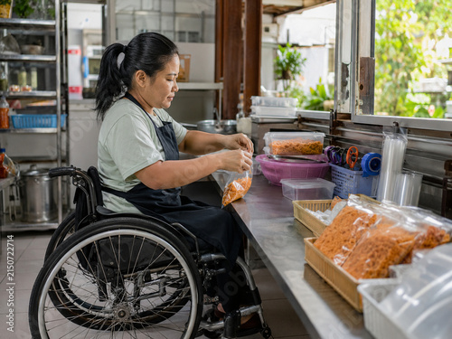 Southeast Asian Wheelchair User Running a Small Food Business