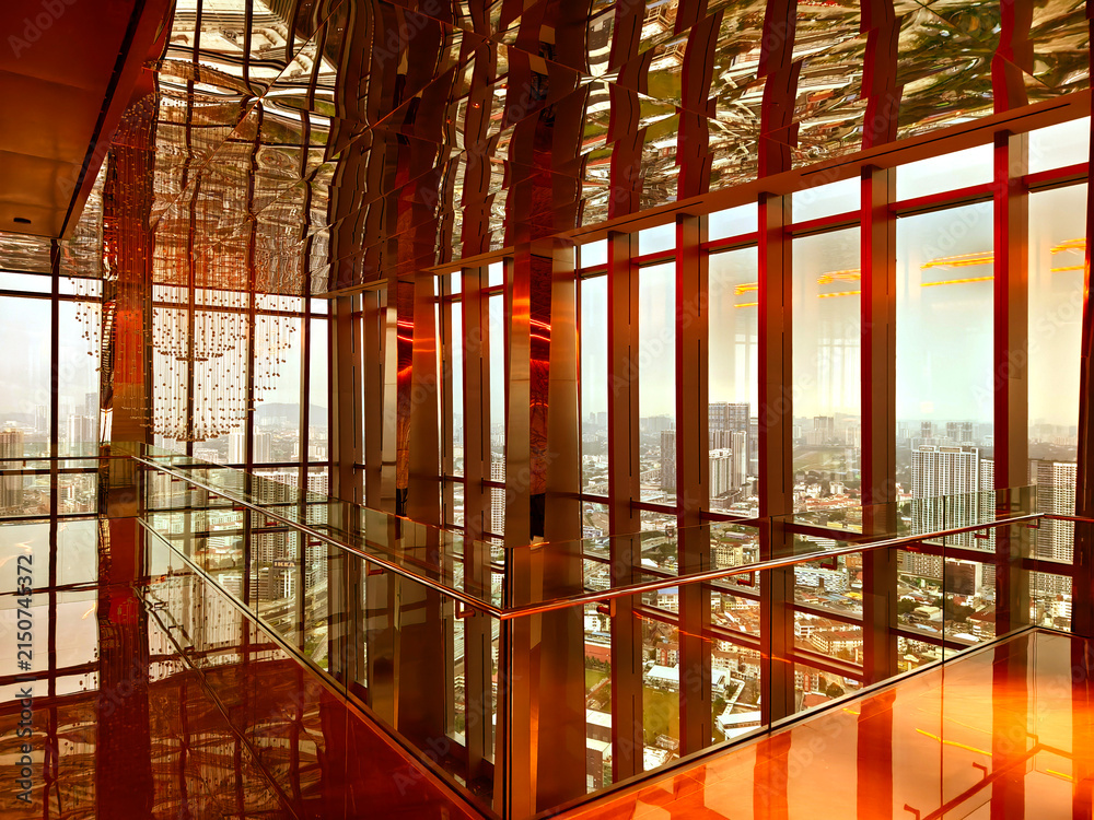 Fototapeta premium Spacious glass atrium with reflections on polished floor and panoramic windows. Empty lobby features