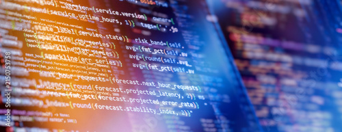 Abstract futuristic programming code on computer screen. Panoramic banner with Python script for server monitoring, predictive data analytics, and glowing neon bokeh.