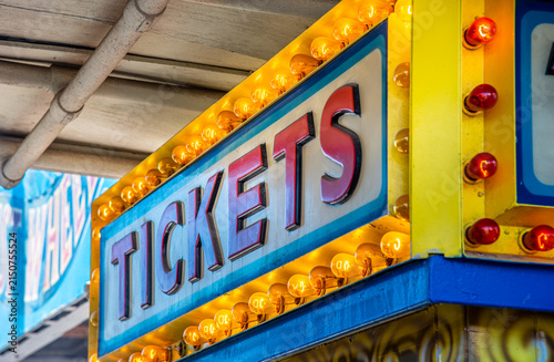 A vibrant pop of nostalgia: this bright yellow, vintage-style marquee sign glows with warm, illuminated bulbs framing the classic word 