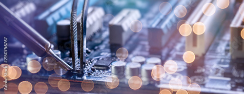 Abstract electronic engineering background. IT hardware repair concept with circuit board components and blurred light effects.