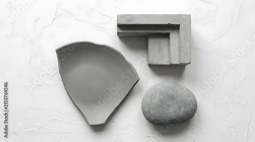 Concrete geometric shapes and stone on white background