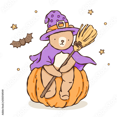 a teddy bear in a witch hat sitting on a pumpkin