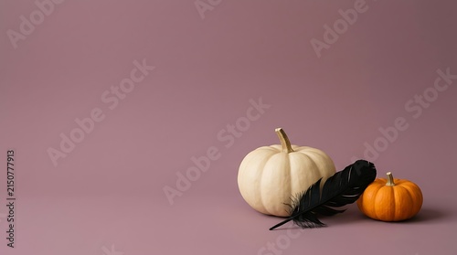 A spooky and delightful halloween still life featuring pumpkins a crow and a soft atmospheric pink backdrop