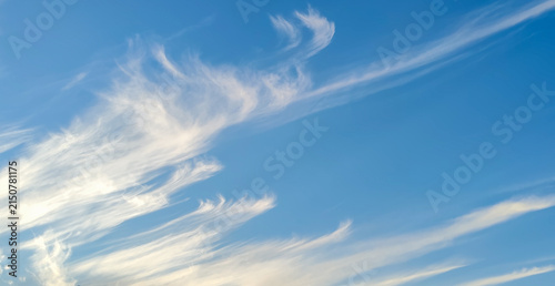 Canvas Print Wispy white cirrus clouds against bright blue sky background