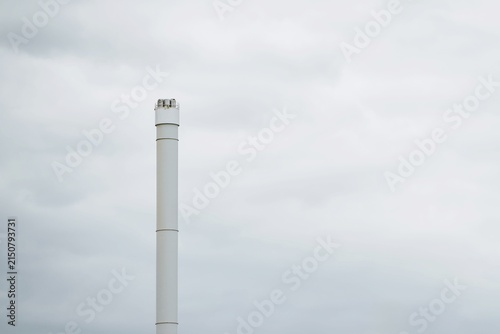 Bild auf Leinwand White chimney stack on cloudy day