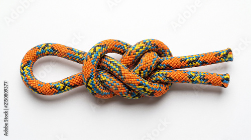 Figure eight knot, colorful climbing rope on white background. Strong figure eight knot provides safety for outdoor activities, securing equipment. Ideal figure eight knot image for hobby instruction,