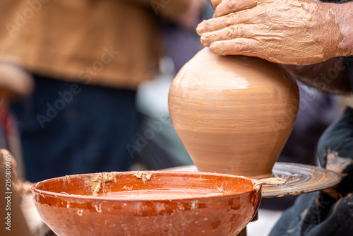 Fotografie Raigame ethnographic festival potter shaping clay on a wheel The Concept of arti