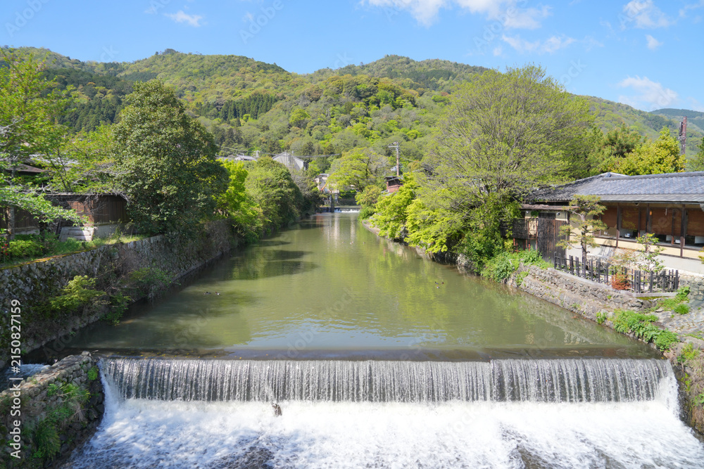 Obraz premium Scenic waterway and small weir in green Arashiyama, Kyoto