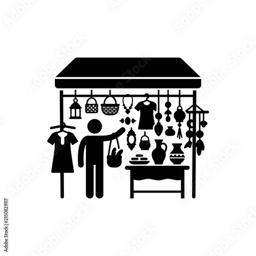 Vendor Selling Handmade Crafts at Outdoor Market Stall.