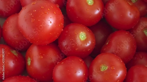Fresh red ripe tomatoes piled together outdoors, local farm harvest, healthy eating, organic produce.