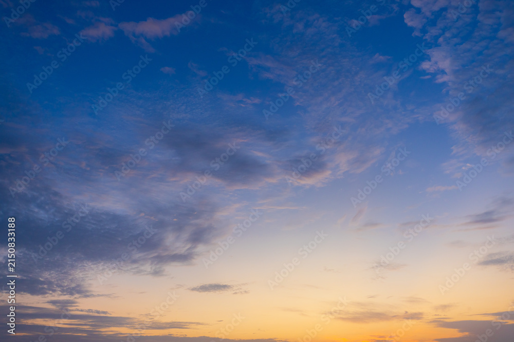 Fototapeta premium Dramatic Altocumulus Clouds at Sunset with Warm Golden Light and Blue Sky,A breathtaking view of a dramatic altocumulus cloudscape illuminated by the warm golden light of a setting sun against a soft 