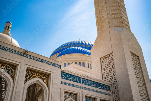 Low angle view of ornate Nursultan mosque entrance portal with blue tile mosaic decoration in Astana