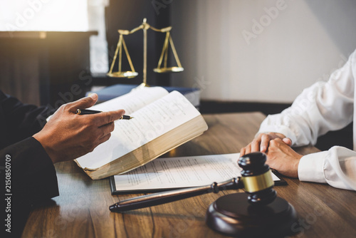 Lawyer Consulting Client on Legal Documents with Gavel and Scales of Justice