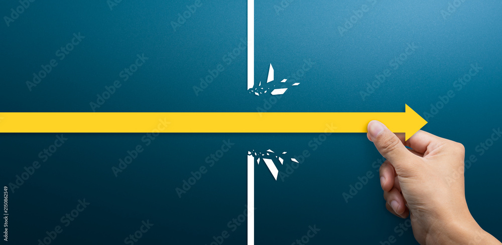 Naklejka premium Breakthrough and Success Concept, Hand Moving Arrow Past Obstacle