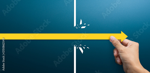 Breakthrough and Success Concept, Hand Moving Arrow Past Obstacle