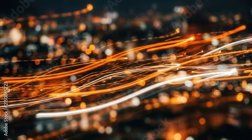 A blurred, abstract image of a cityscape with streaks of light and bokeh effects, set against a dark background.