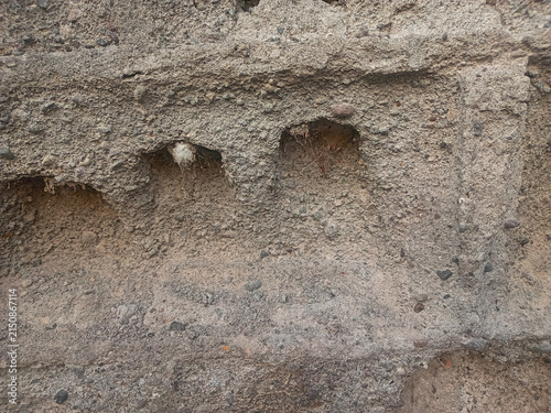 Close-up shot of a ruined damaged wall showing broken bricks and cracked concrete texture