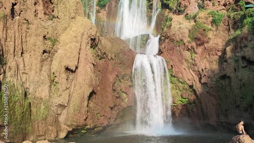 Cinematic slow motion shot of thundering water plunges and vibrant rainbow mist at Ouzoud Waterfalls