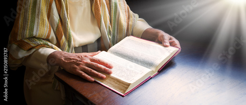 Old man reading a big book