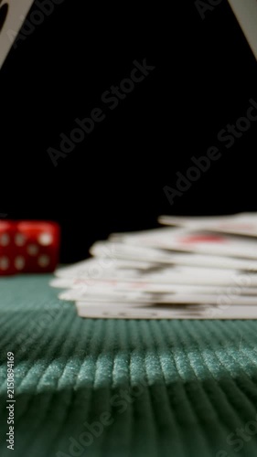 MACRO: Dolly shot under a playing cards on a green poker table