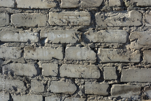 Obraz na plátne Construction and renovation work, a wall with imperfections and unevenness, the first masonry