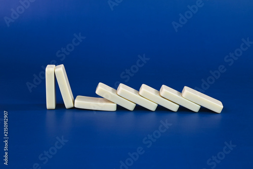 Domino pieces falling on a blue background.