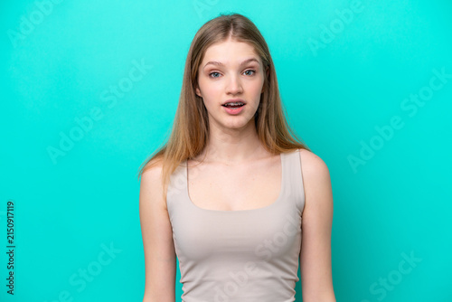 Konstfotografi Teenager Russian girl isolated on blue background with surprise facial expressio