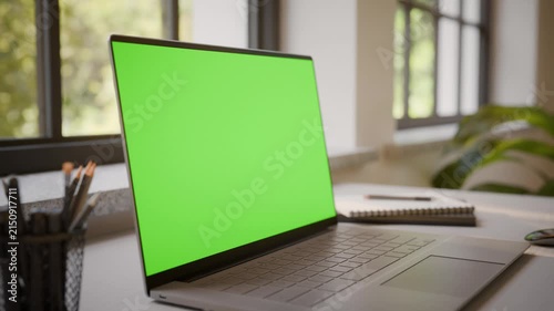 Laptop PC with Green Screen on Office Desk in Sunny Room - Perspective View, Looped Video