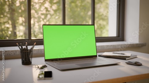 Laptop PC with Green Screen on Office Desk in Sunny Room - Perspective View, Looped Video